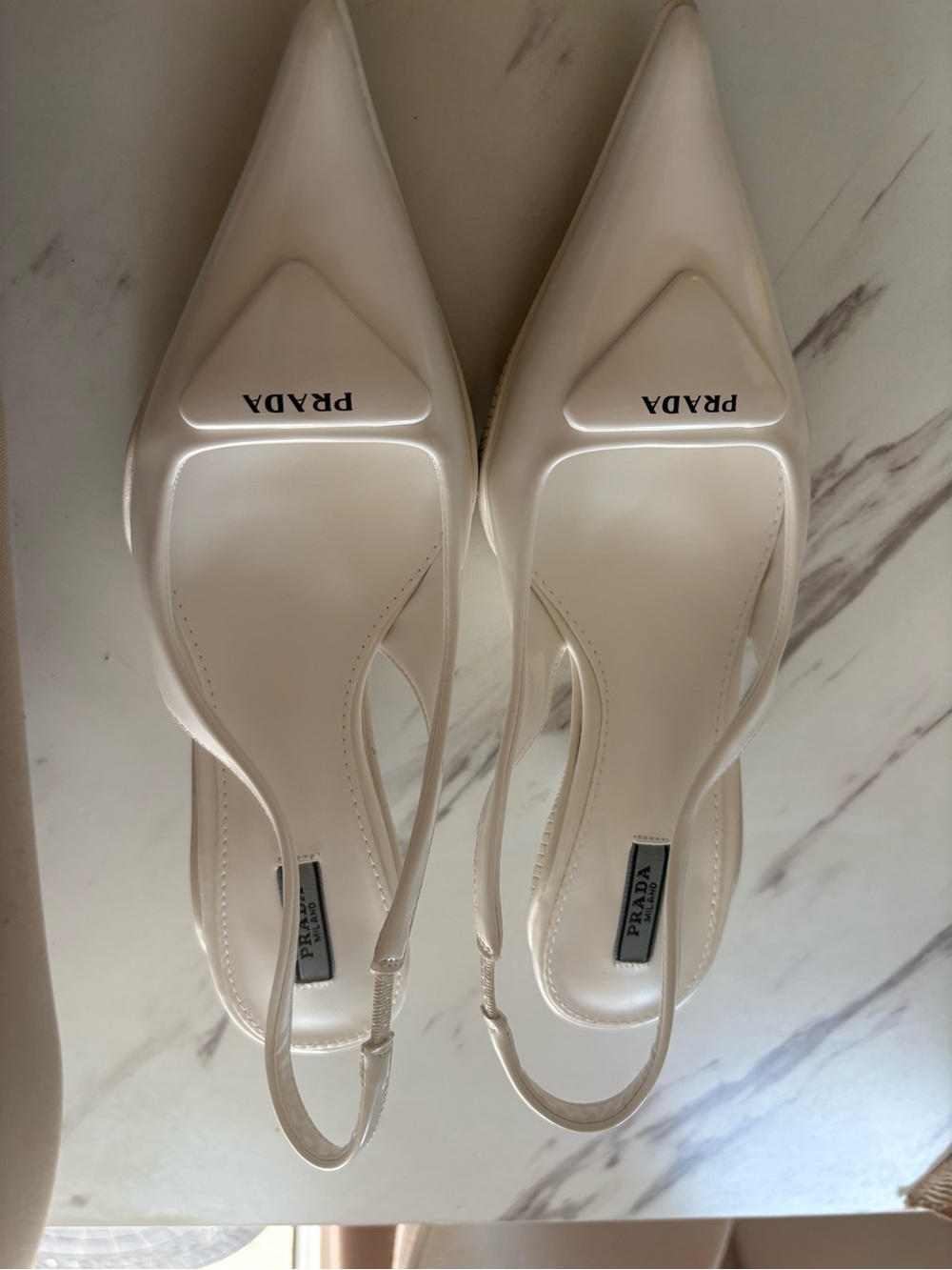 Prada Brushed Leather Slingback Pumps in white.